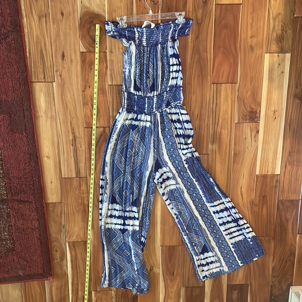Tie dye off shoulder blue jumpsuit with elastic empire waist.